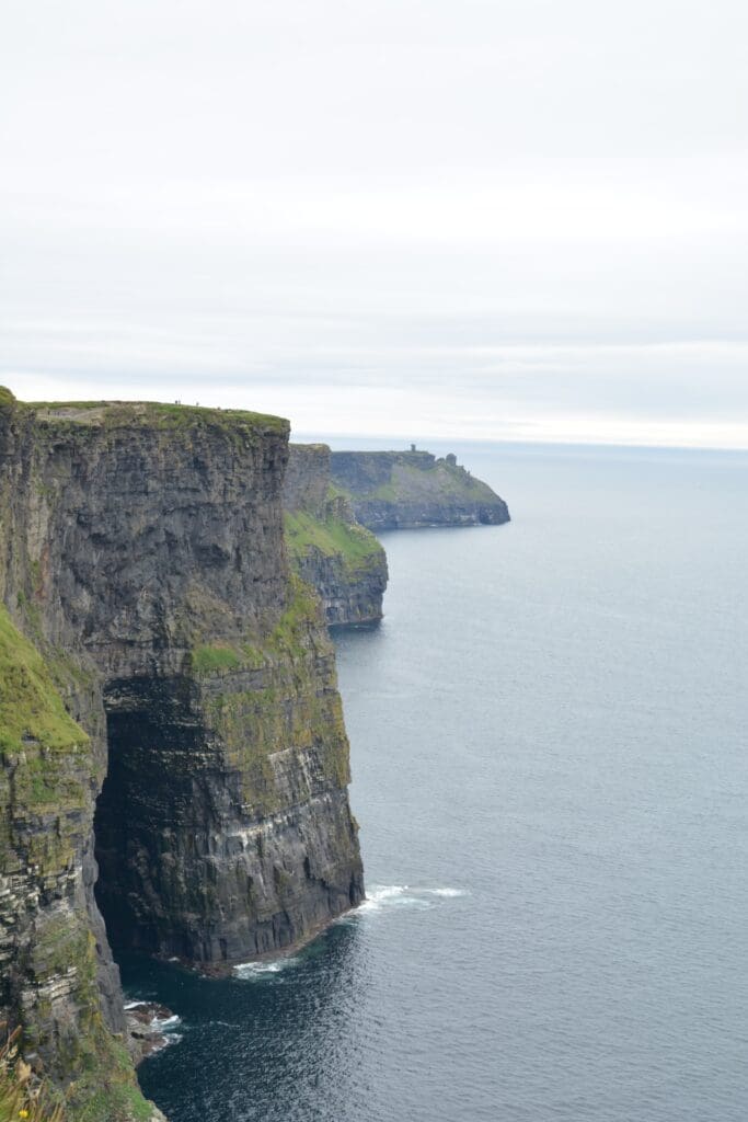 Cliffs of Mohr in Ireland amongst ocean and overcast skies.
